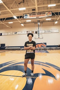 a young woman standing on a basketball court